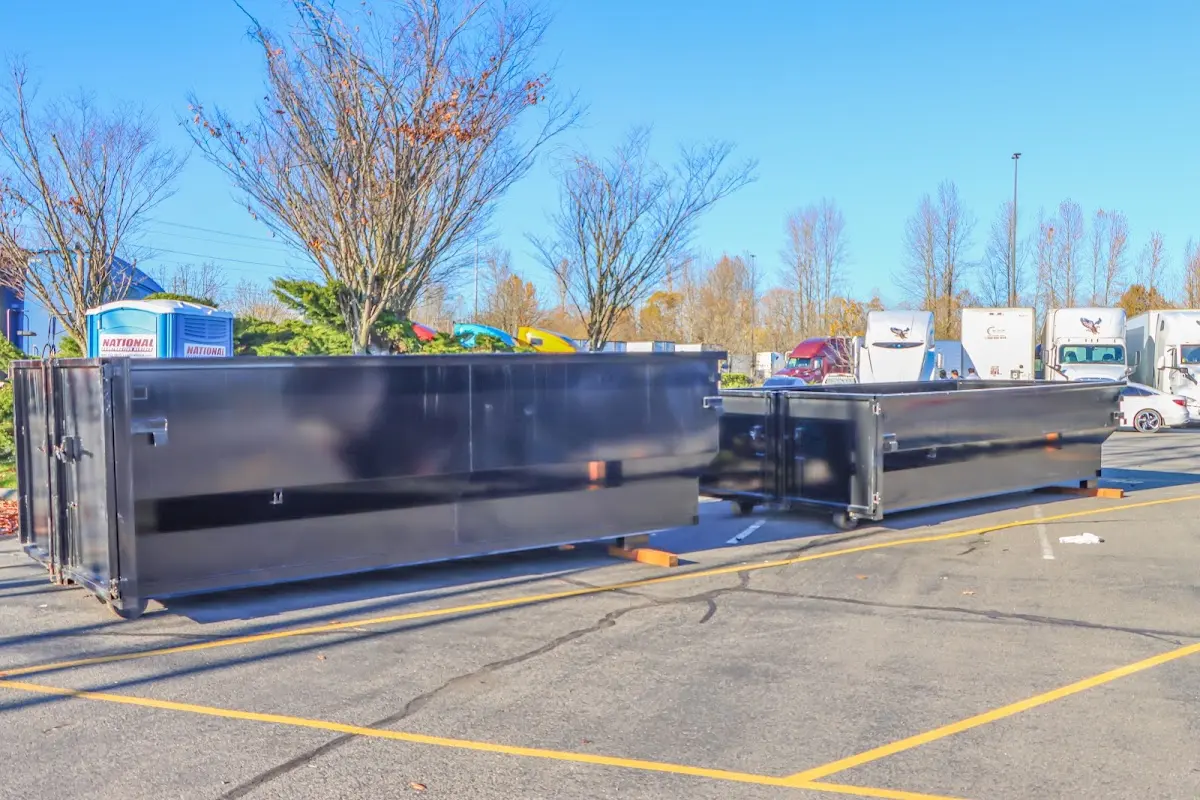 Professional dumpster rental service with roll-off container on residential driveway in Sequim